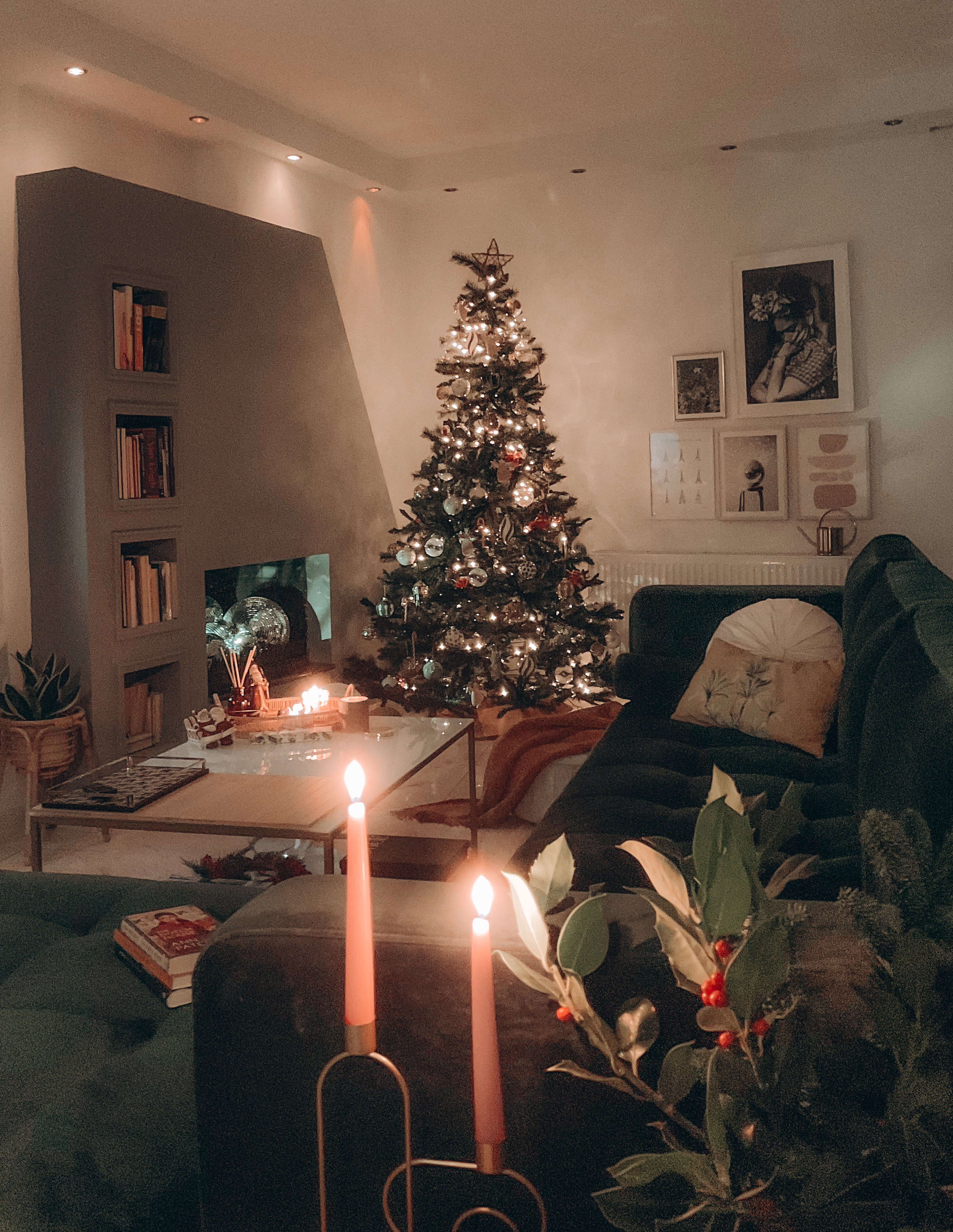 living room with Christmas tree green velvet sofa and fireplace with disco balls